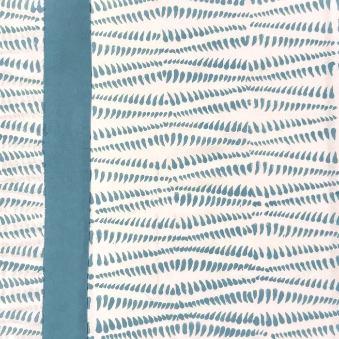 Patterned fabric with blue and white design on a plain background