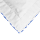 White fabric with blue embroidery on a white background
