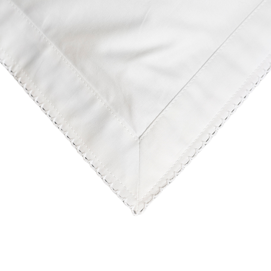 White fabric with white embroidery on a white background