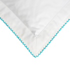 White fabric with turquoise embroidery on a white backgroun