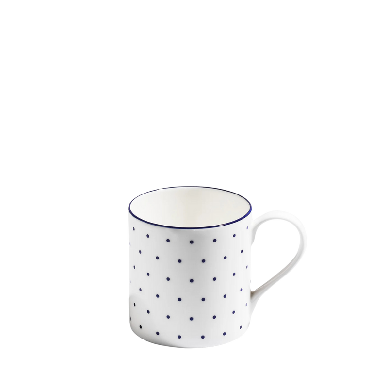 Blue and white polka dot bone china mug on white background