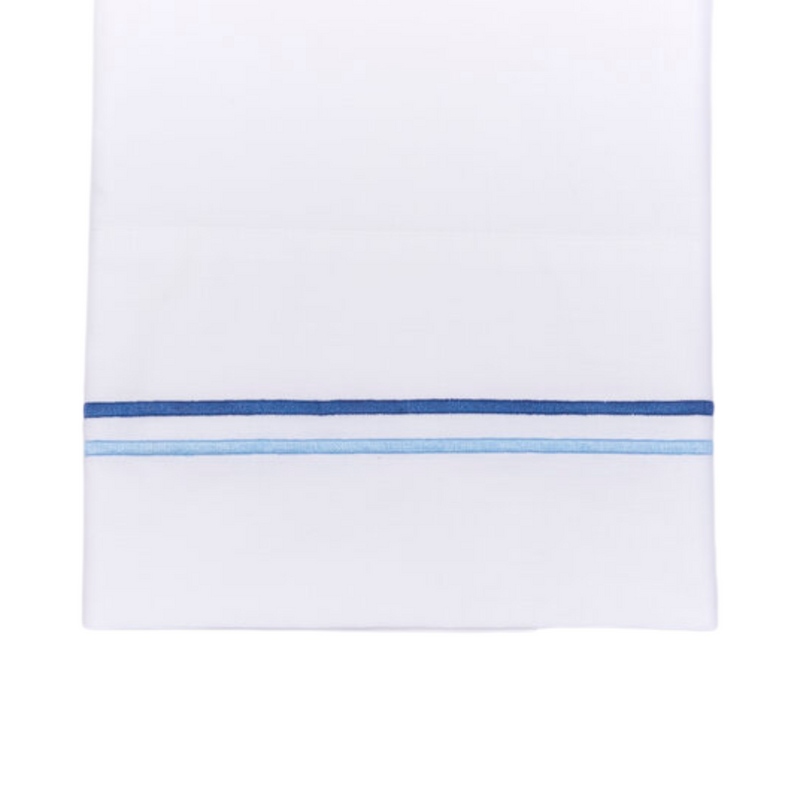 White sheet with two blue embroidered lines on white background
