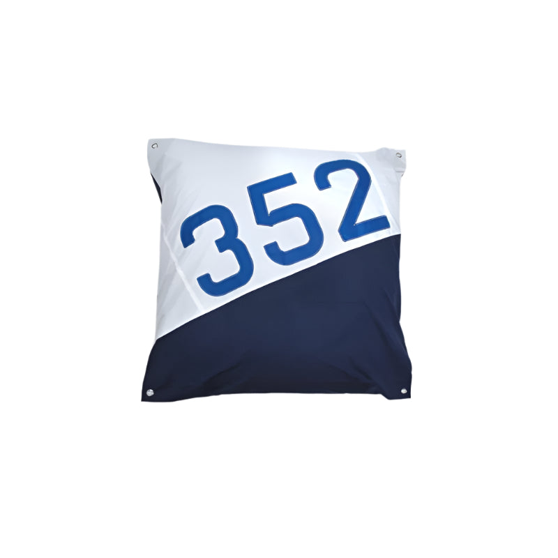 Pillow with blue number '352' on a white background
