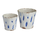Two ceramic pots with blue speckles on a white background