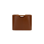 Brown leather magazine rack on a white background