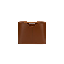 Brown leather magazine rack on a white background